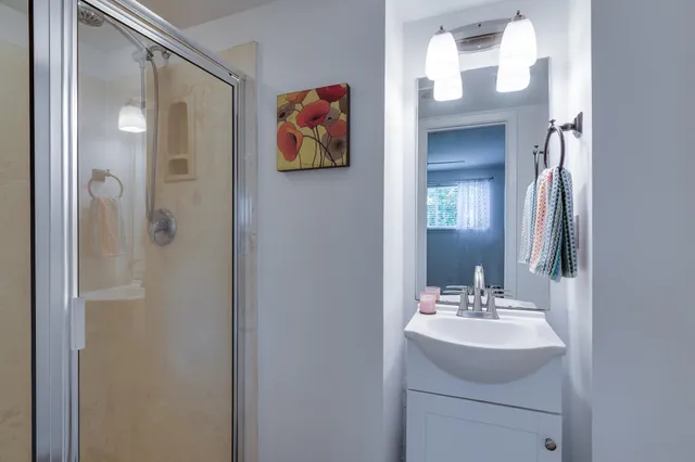 a bathroom with a sink vanity and mirror
