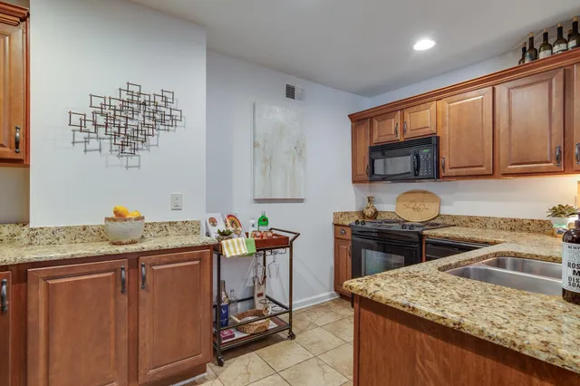 a kitchen with a stove a sink a microwave and wooden cabinets