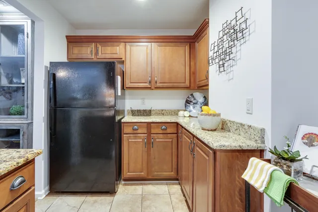 a kitchen with a refrigerator and a sink