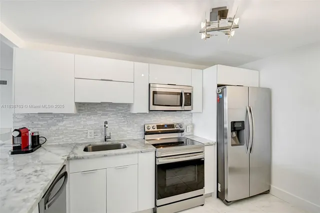 a kitchen with stainless steel appliances a stove a microwave and a refrigerator