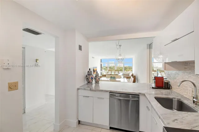 a kitchen with a sink cabinets and window