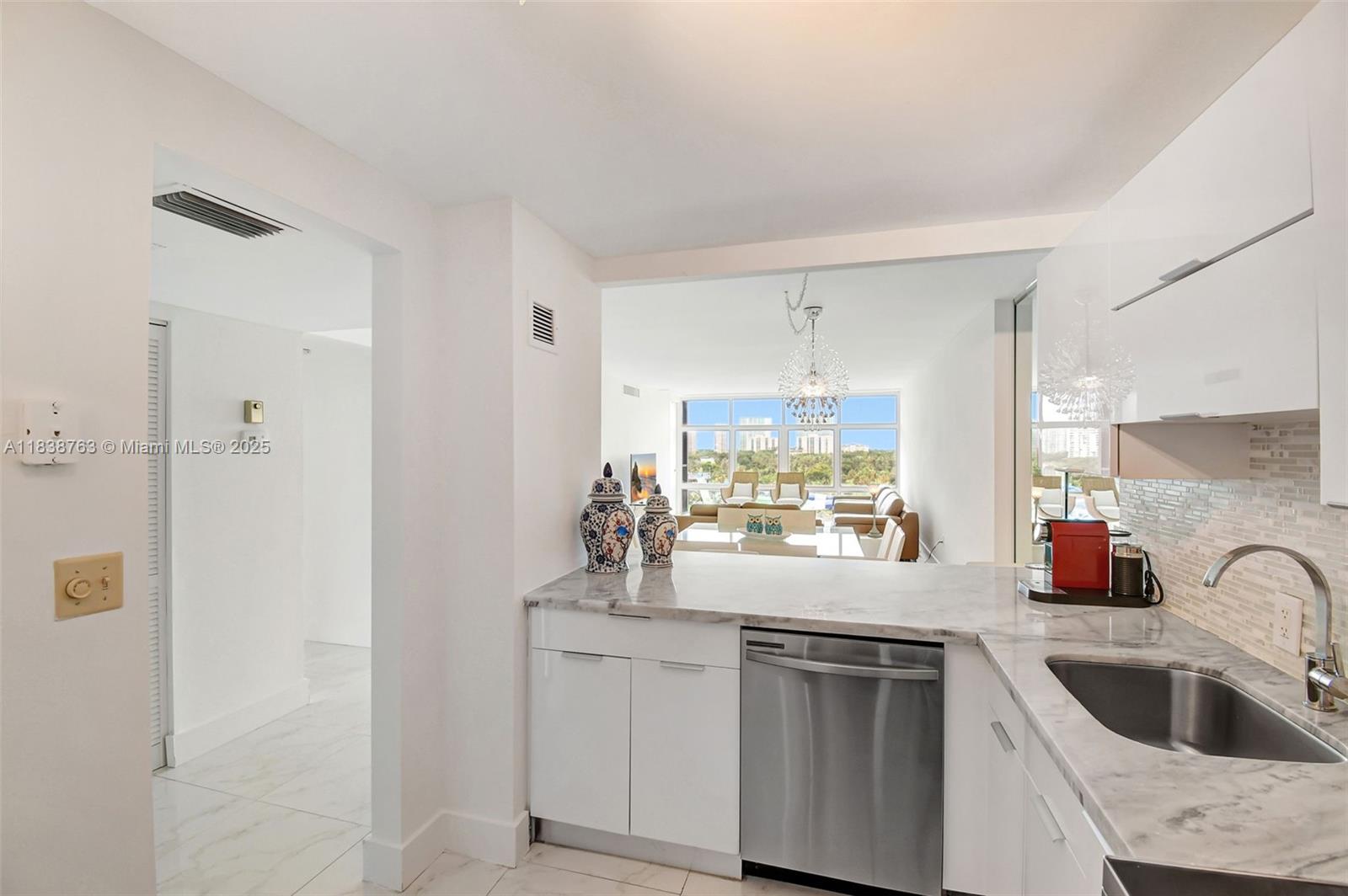20100 West Country Club Drive, Unit 1005 Aventura, FL 33180 - Photo 12 of 36 a kitchen with a sink cabinets and window
