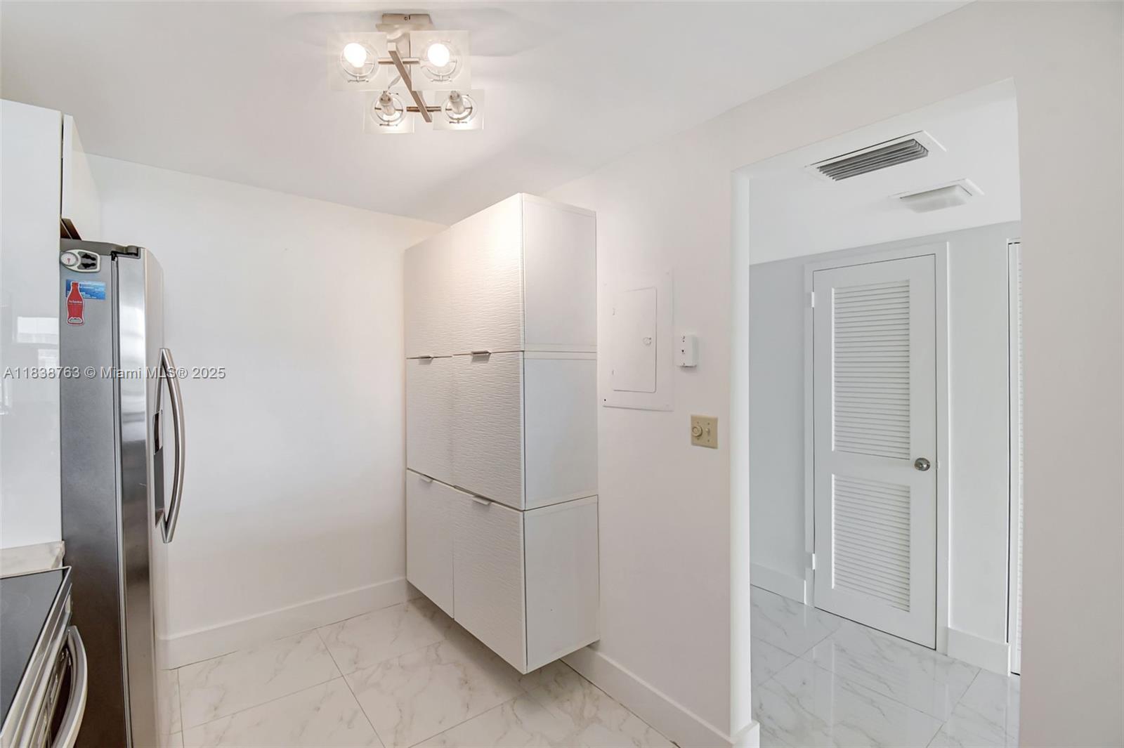 20100 West Country Club Drive, Unit 1005 Aventura, FL 33180 - Photo 13 of 36 a view of hallway with cabinets