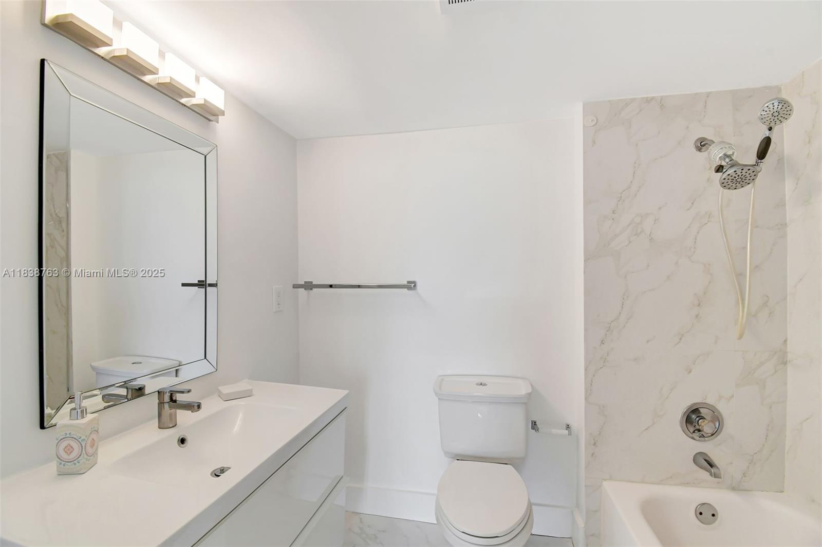 20100 West Country Club Drive, Unit 1005 Aventura, FL 33180 - Photo 17 of 36 a bathroom with a sink a toilet and shower