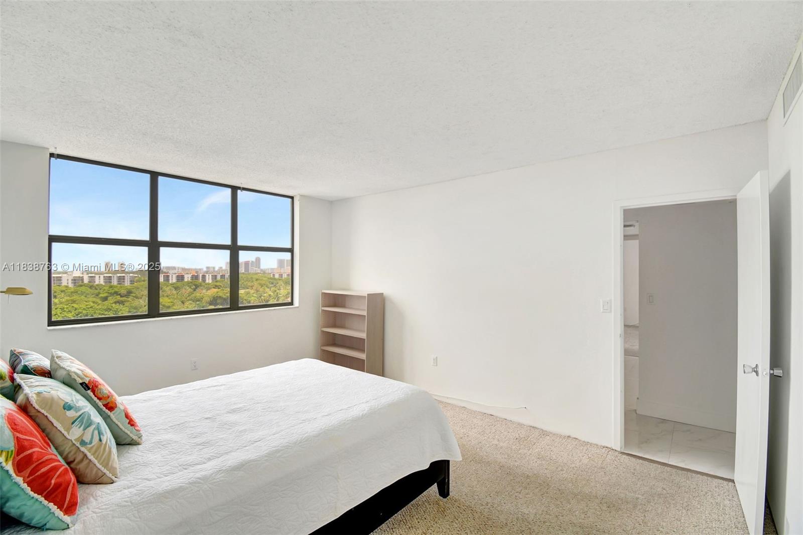 20100 West Country Club Drive, Unit 1005 Aventura, FL 33180 - Photo 20 of 36 a bedroom with a bed and a window