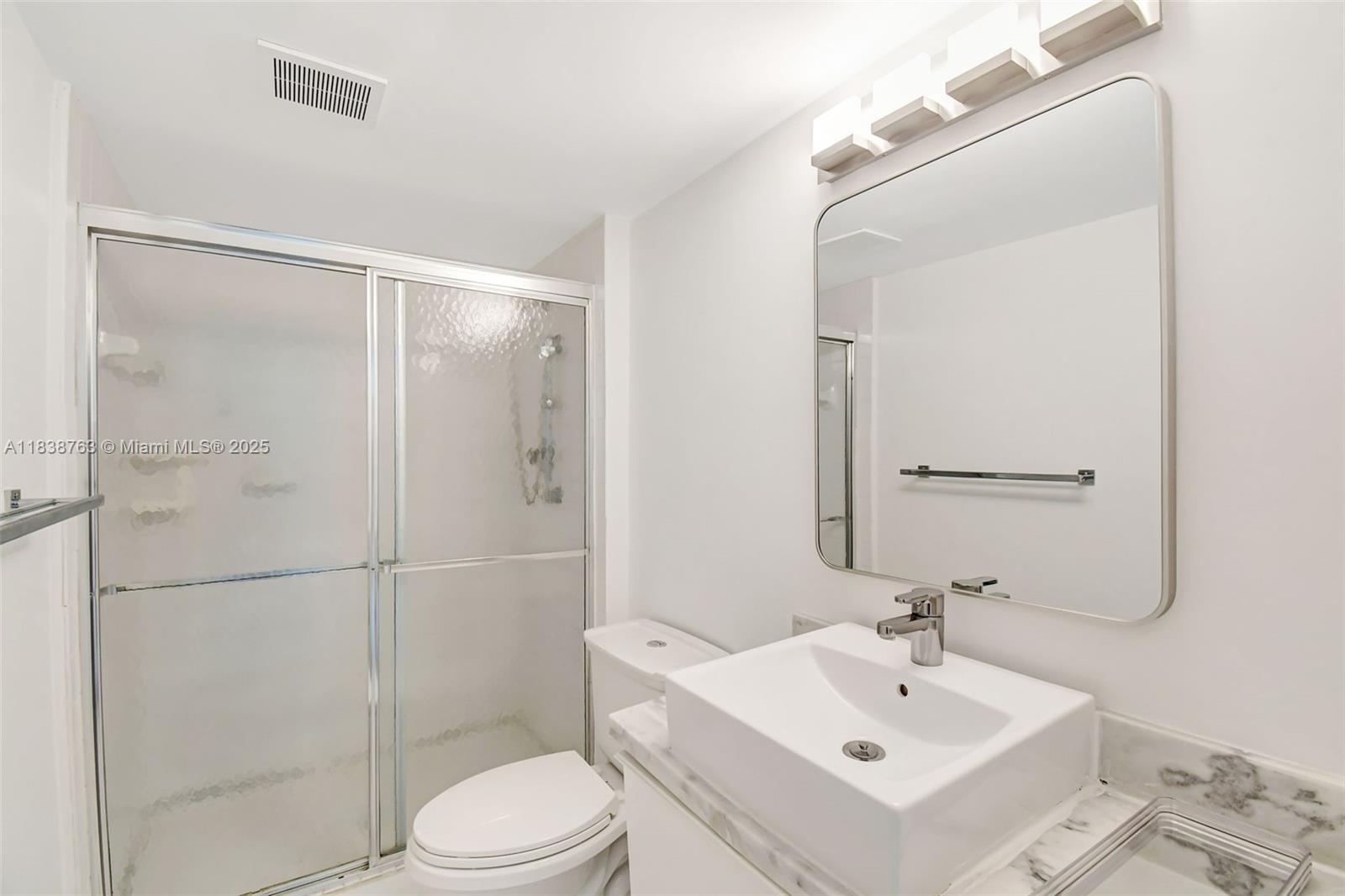 20100 West Country Club Drive, Unit 1005 Aventura, FL 33180 - Photo 22 of 36 a bathroom with a sink mirror shower and toilet