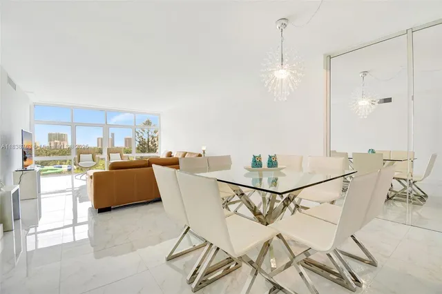 a view of a dining room with furniture and a floor to ceiling window