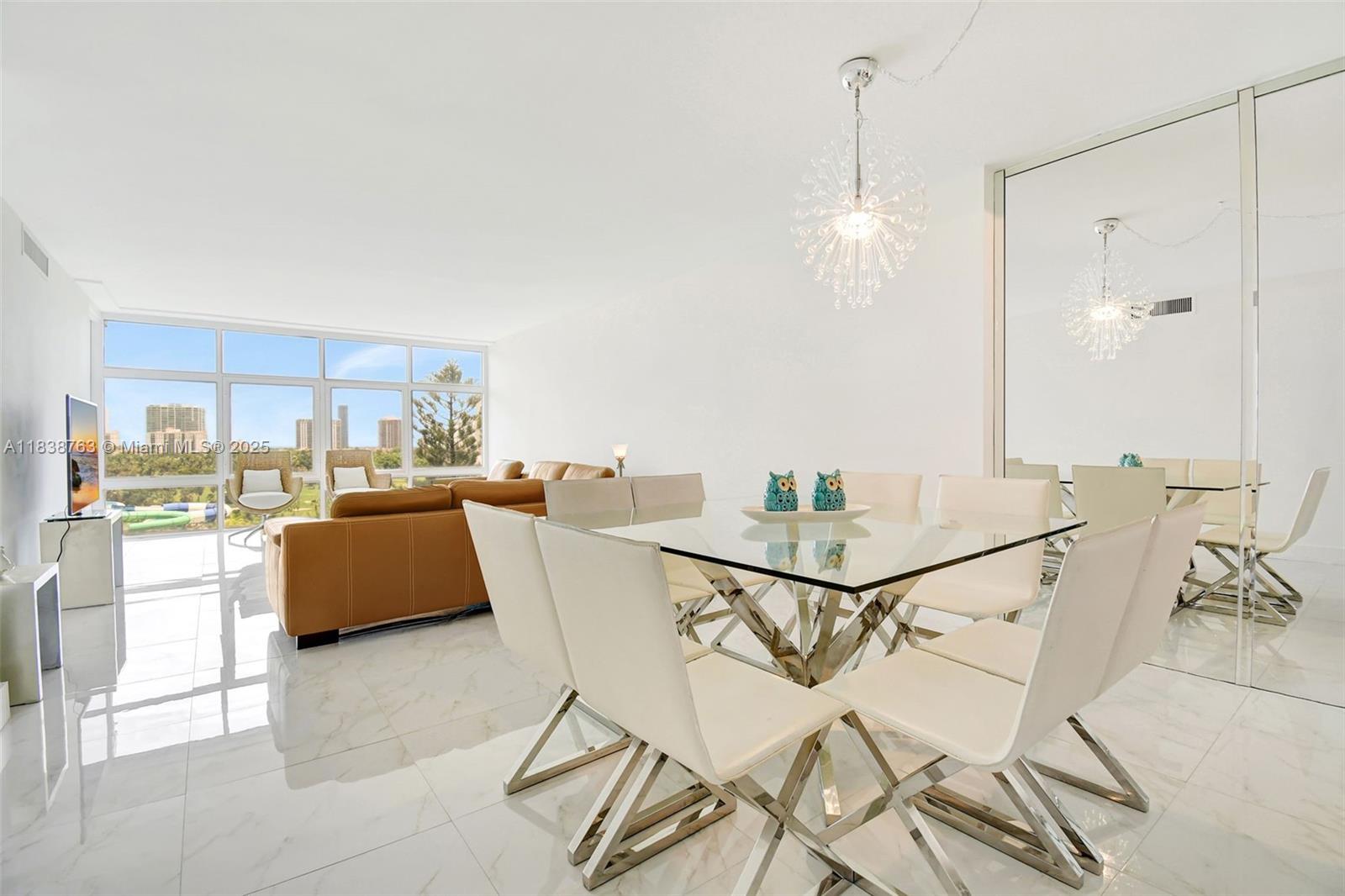 20100 West Country Club Drive, Unit 1005 Aventura, FL 33180 - Photo 6 of 36 a view of a dining room with furniture and a floor to ceiling window