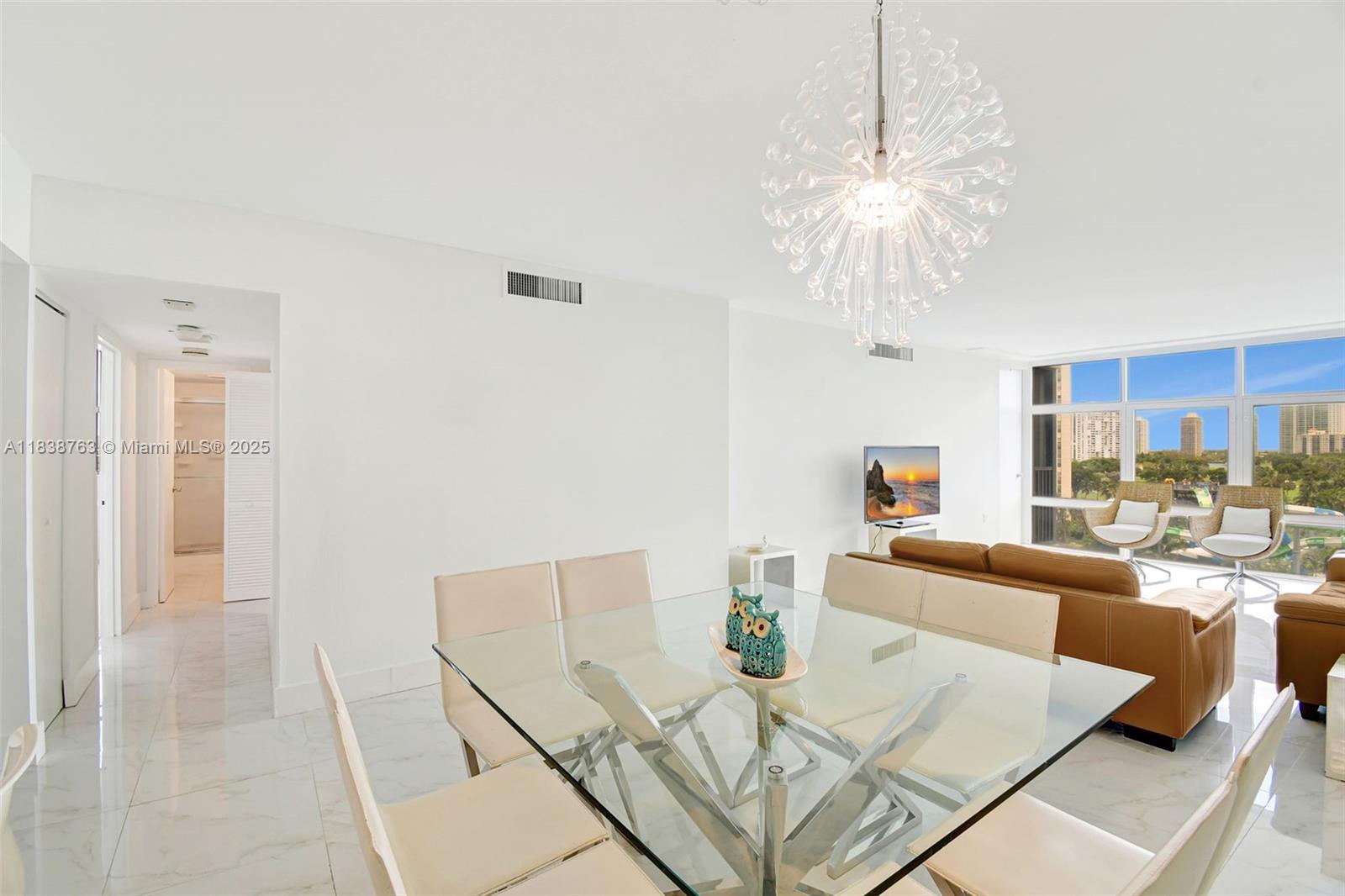 20100 West Country Club Drive, Unit 1005 Aventura, FL 33180 - Photo 7 of 36 a view of a dining room with furniture