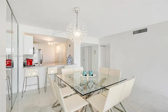 a view of a dining room with furniture and a chandelier
