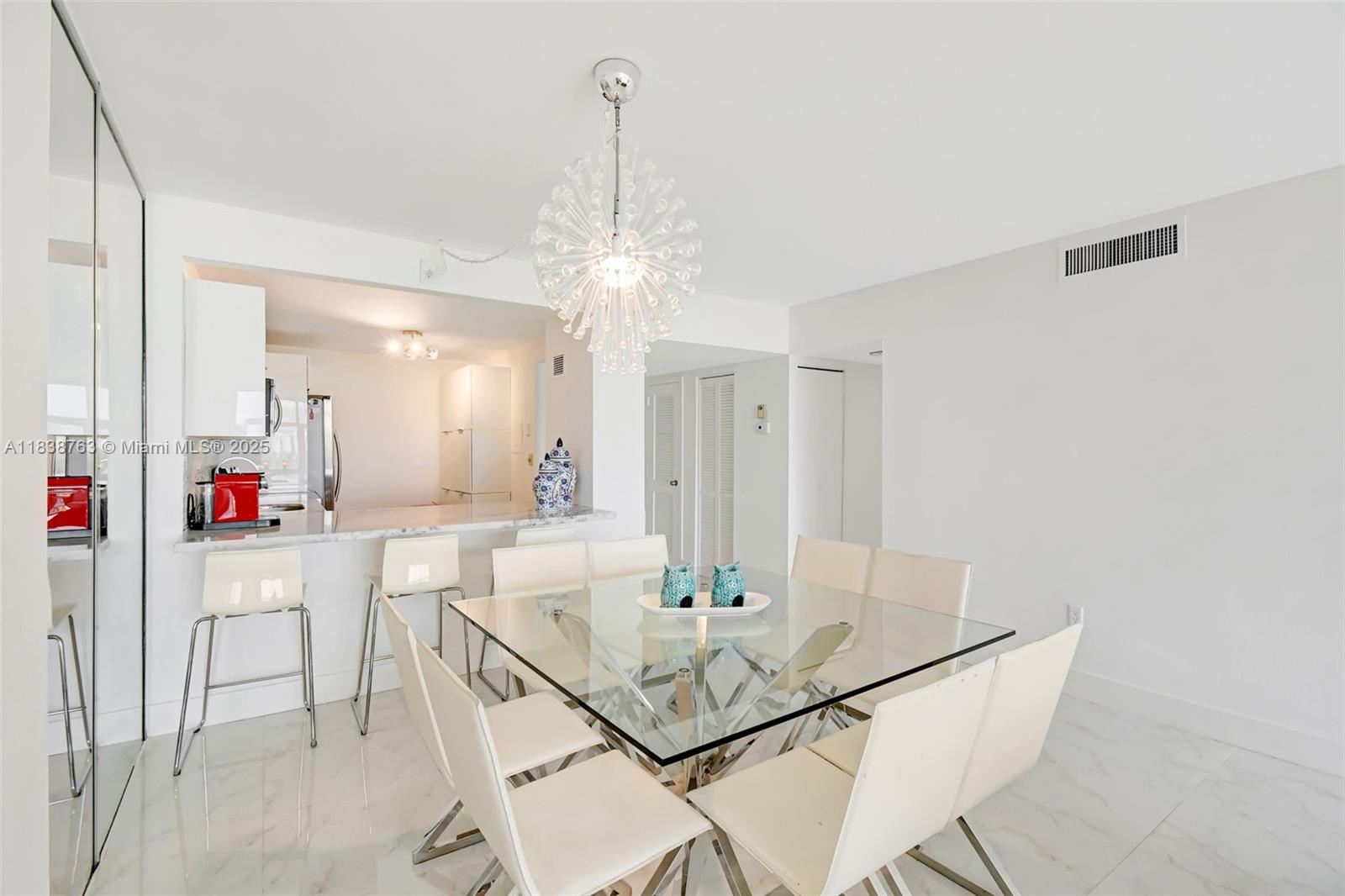 20100 West Country Club Drive, Unit 1005 Aventura, FL 33180 - Photo 8 of 36 a view of a dining room with furniture and a chandelier