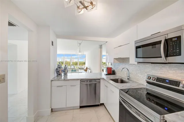 a kitchen with a sink stove and microwave