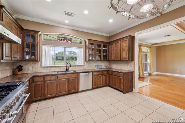 a large kitchen with cabinets a sink and appliances