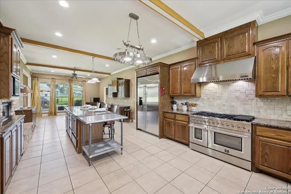 a kitchen with stainless steel appliances granite countertop a stove and cabinets