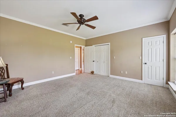 a view of a livingroom with a ceiling fan and window