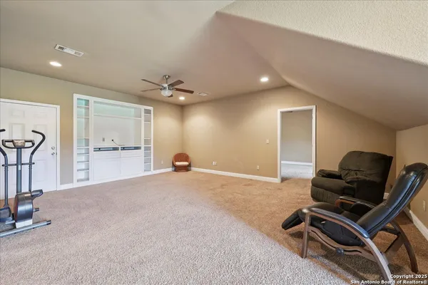 a view of a livingroom with furniture and gym equipment
