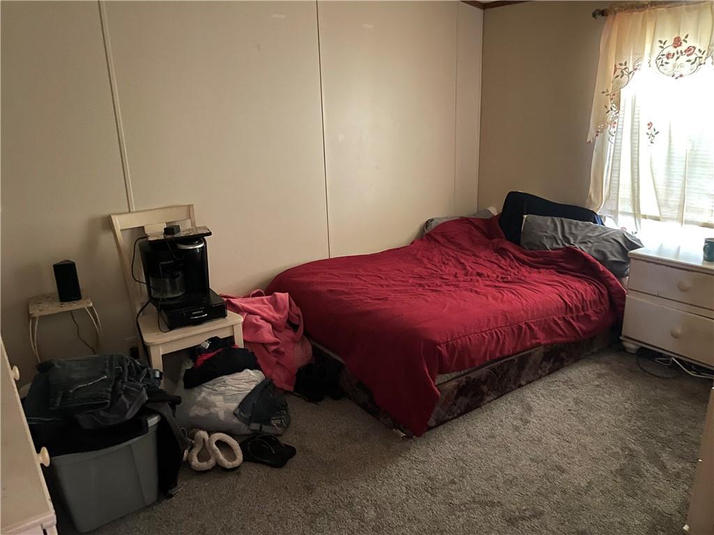 45-47 Ray Road Greenville, PA 16125 - Photo 13 of 15 a bedroom with a bed a couch and a window