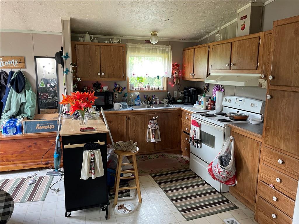 45-47 Ray Road Greenville, PA 16125 - Photo 5 of 15 a kitchen with a stove and a refrigerator
