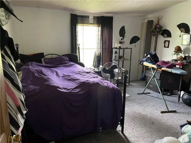 a bedroom with a bed and a table in it