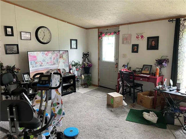 a kitchen with a table chairs refrigerator and cabinets