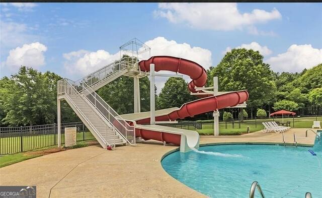 428 River Walk Covington, GA 30014 - Photo 2 of 6 swimming pool view with a seating space