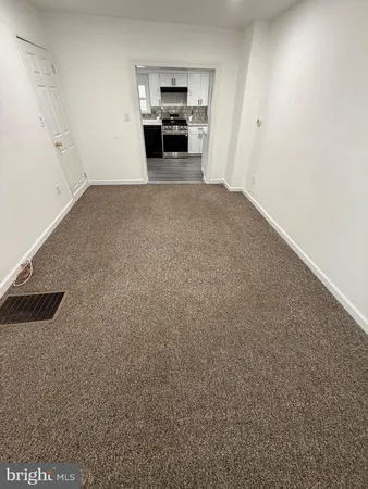 a view of empty room with furniture and cabinet