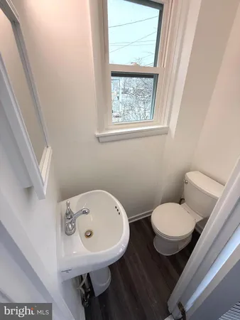 a bathroom with a sink a mirror and a toilet