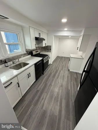 a kitchen with a stove a sink and a refrigerator