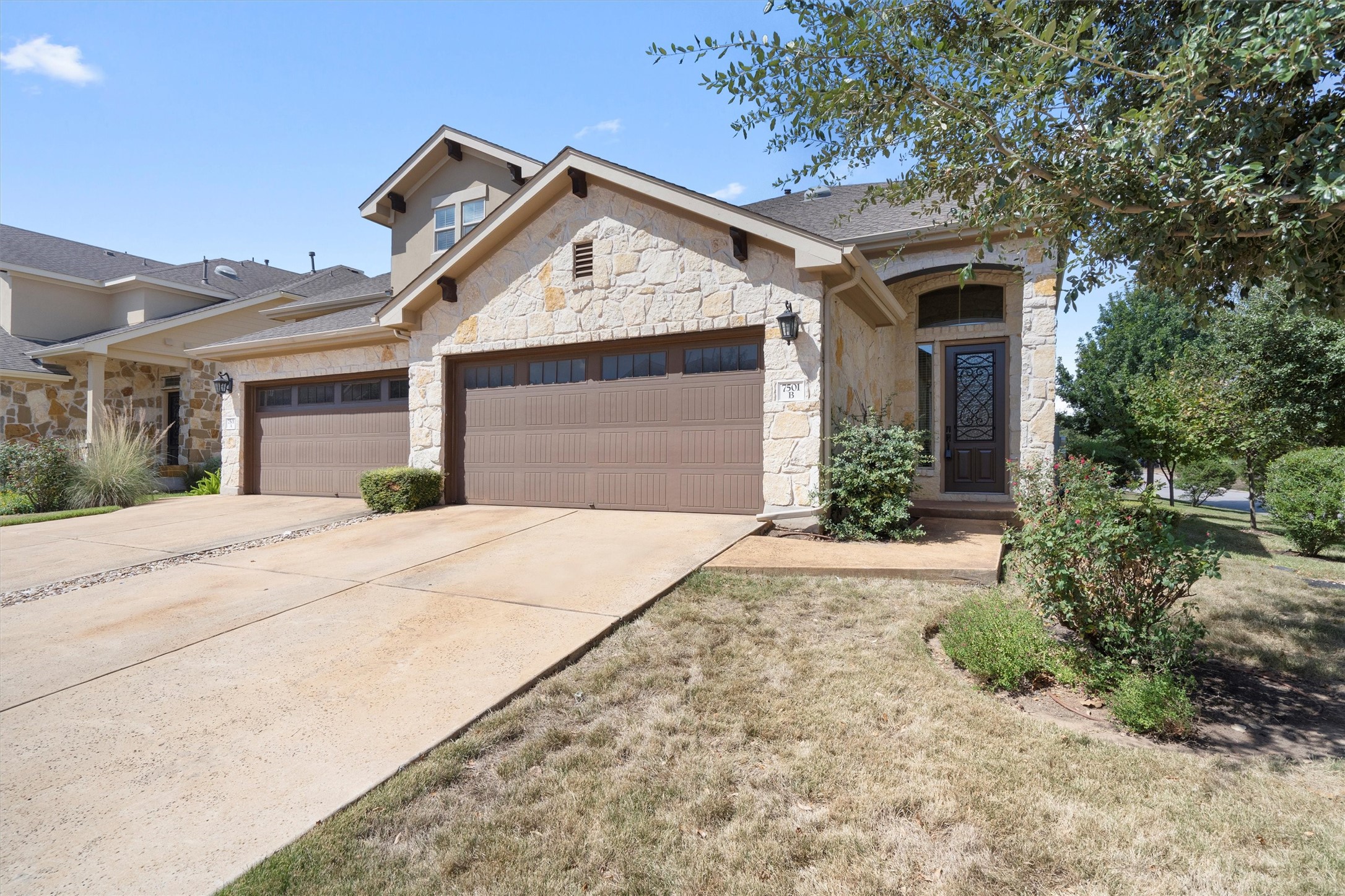a front view of a house with a yard and garage