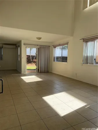 a view of an empty room with a fireplace and a window