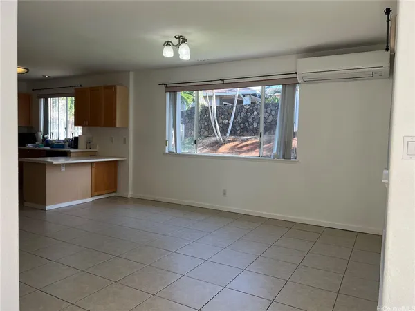 a view of a kitchen with microwave and windows