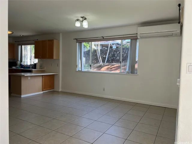 a view of a kitchen with microwave and windows