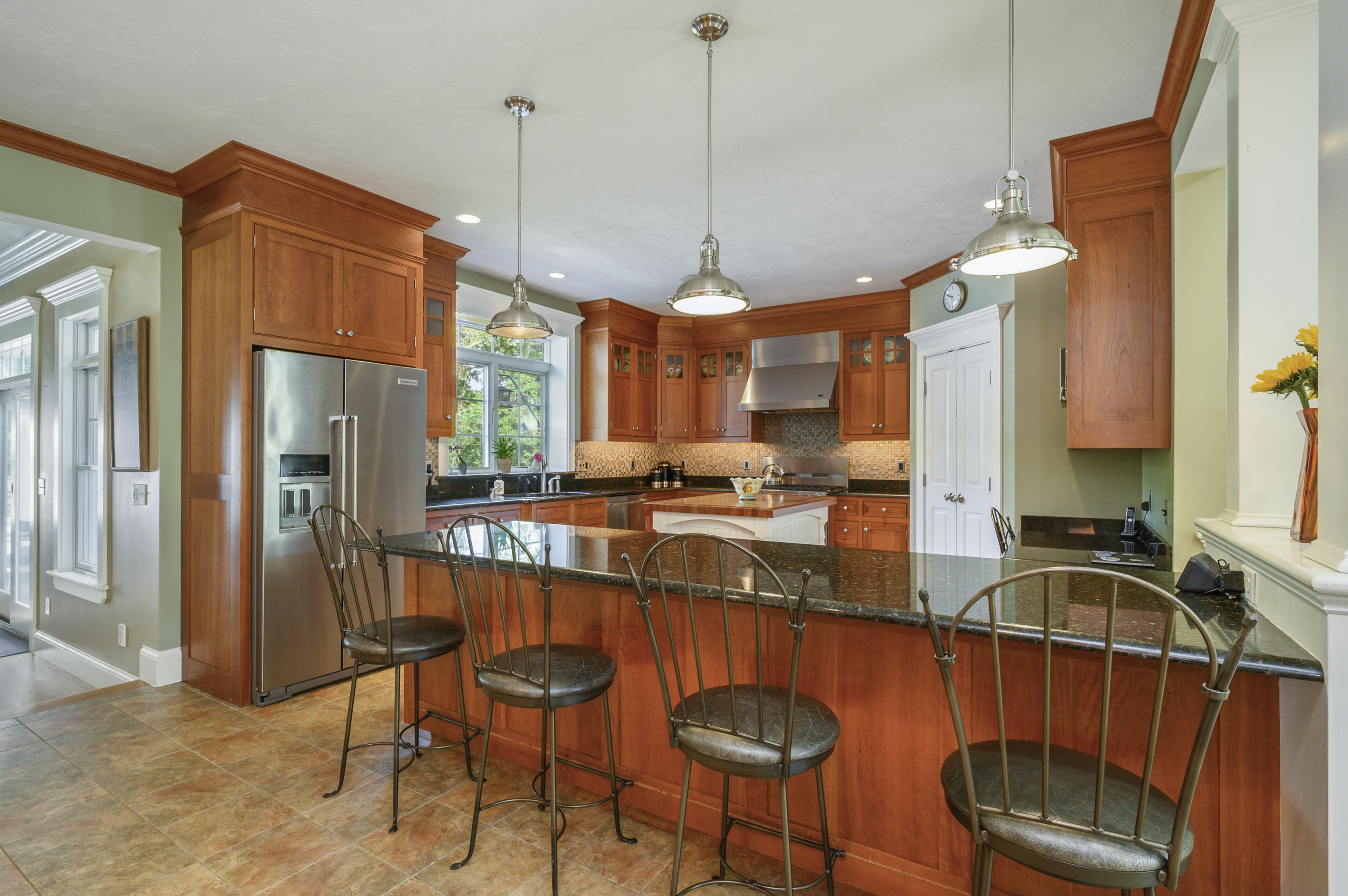 80 Crocker Road West Barnstable, MA 02668 - Photo 12 of 35 a kitchen with stainless steel appliances granite countertop a sink a stove a refrigerator a washer dryer and a dining table