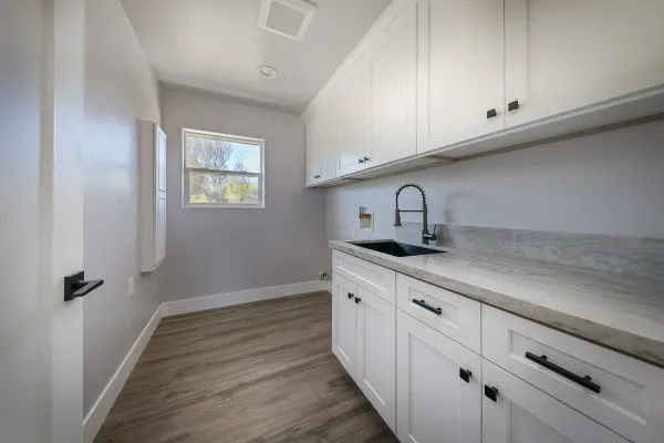 a kitchen with sink and cabinets