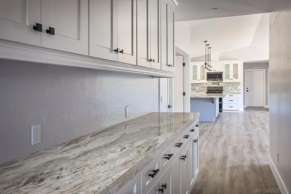 a kitchen with granite countertop a sink and cabinets