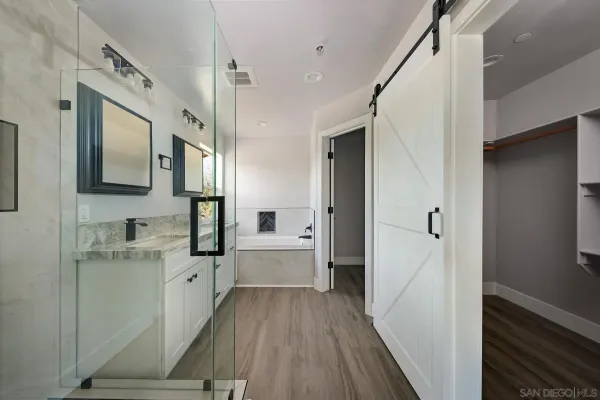 a large white kitchen with a sink a refrigerator and a stove