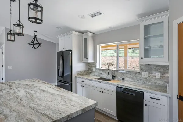 a kitchen with a sink appliances and a window