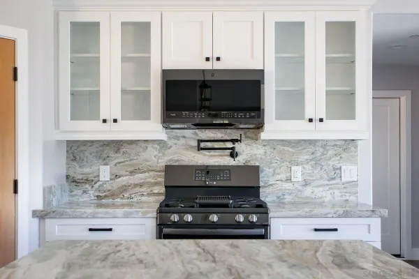 a kitchen with appliances a stove and cabinets