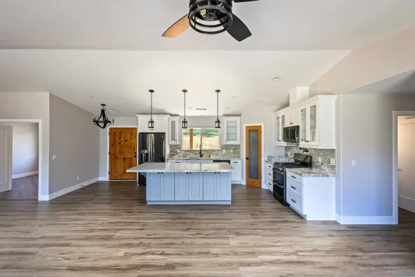 a kitchen with stainless steel appliances granite countertop a refrigerator and a stove top oven