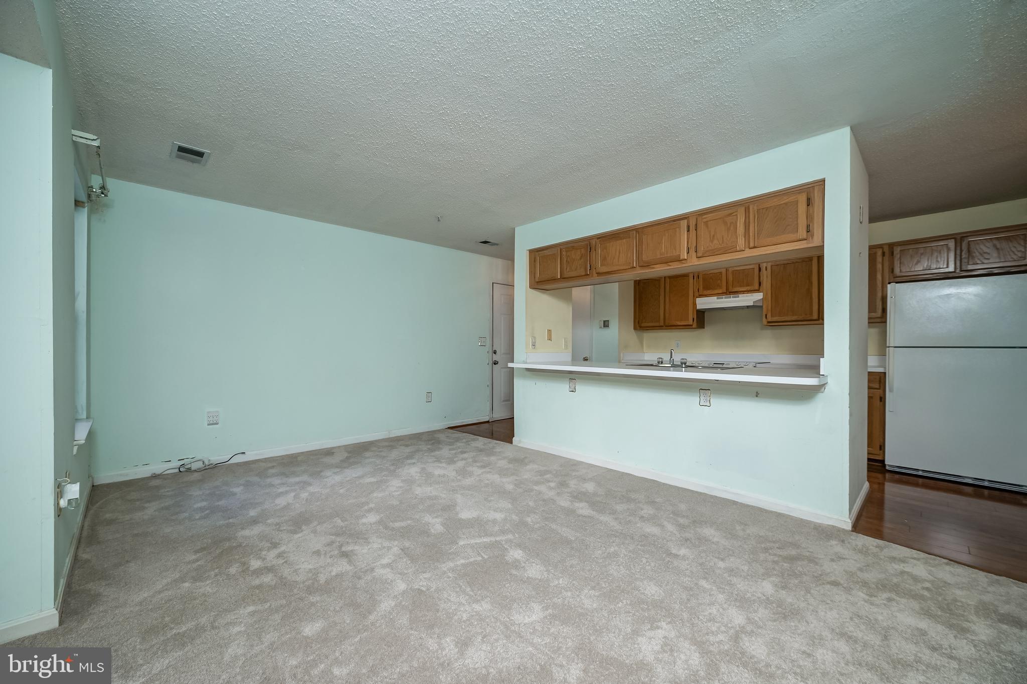 14202 Valleyfield Drive, Unit 338 Silver Spring, MD 20906 - Photo 11 of 38 a view of empty room with wooden floor and cabinet
