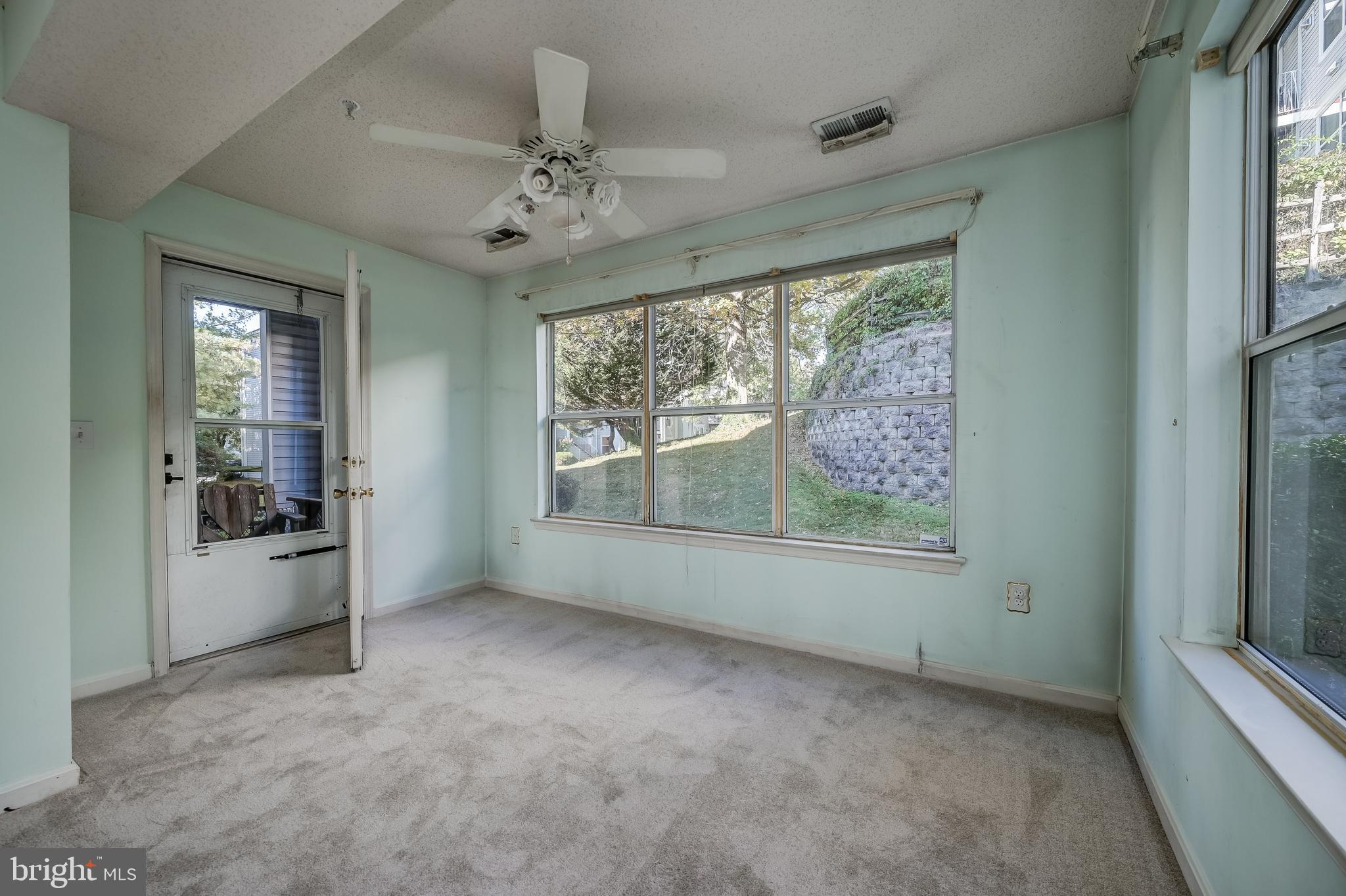 14202 Valleyfield Drive, Unit 338 Silver Spring, MD 20906 - Photo 13 of 38 en empty room with windows and ceiling fan