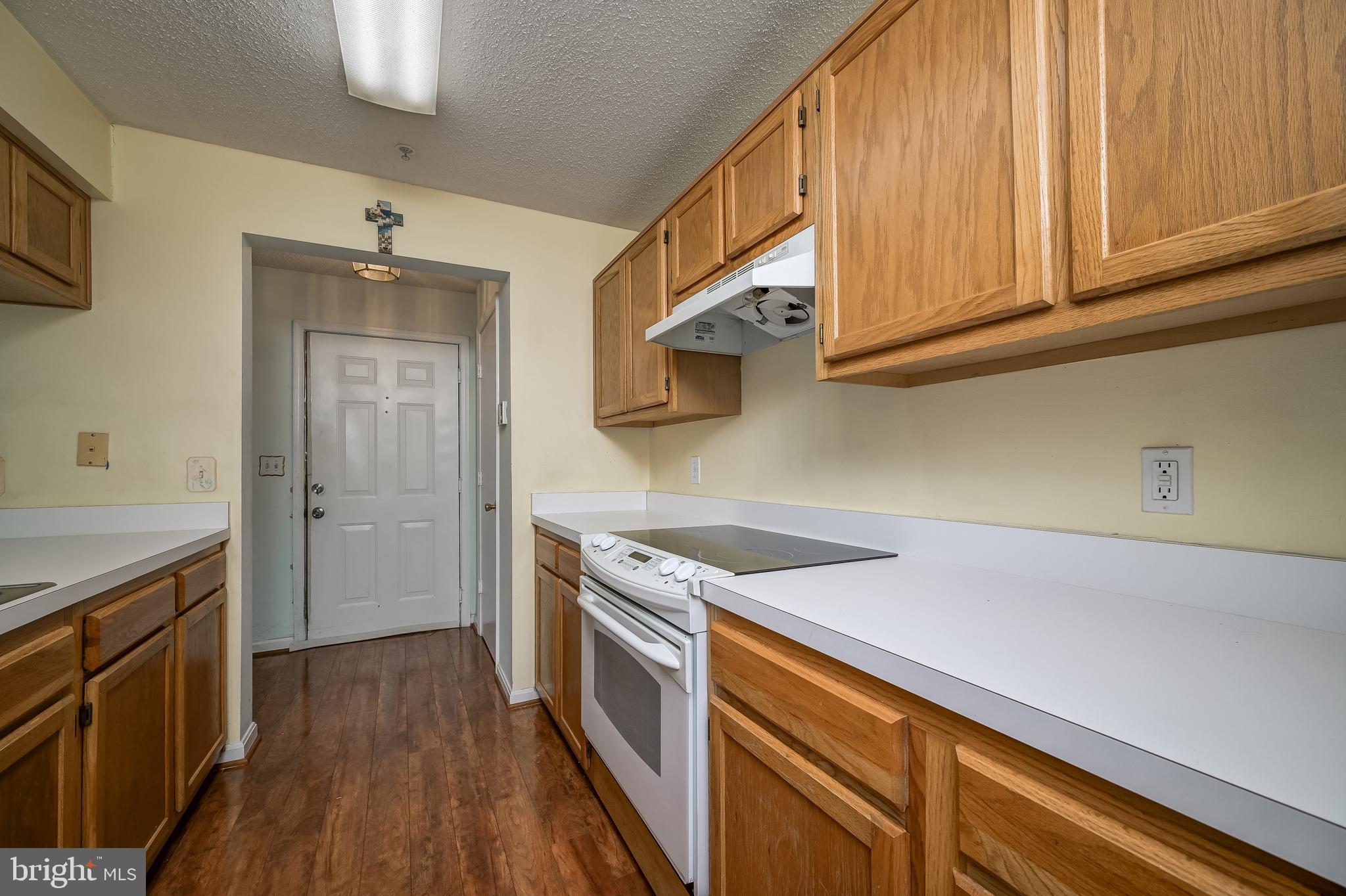 14202 Valleyfield Drive, Unit 338 Silver Spring, MD 20906 - Photo 21 of 38 a kitchen with stainless steel appliances granite countertop a sink and cabinets with wooden floor