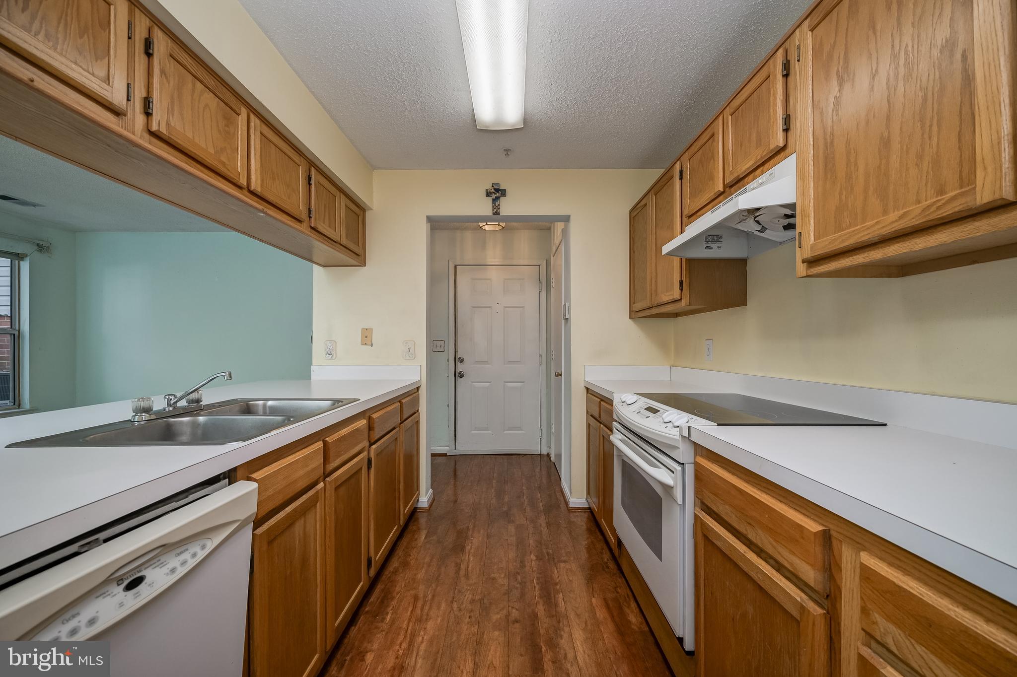 14202 Valleyfield Drive, Unit 338 Silver Spring, MD 20906 - Photo 23 of 38 a kitchen with a sink stove and cabinets