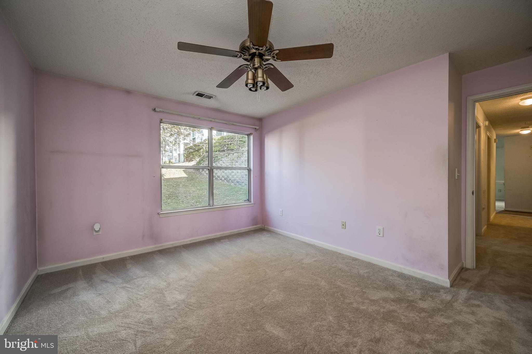 14202 Valleyfield Drive, Unit 338 Silver Spring, MD 20906 - Photo 25 of 38 a view of a livingroom with a ceiling fan and window