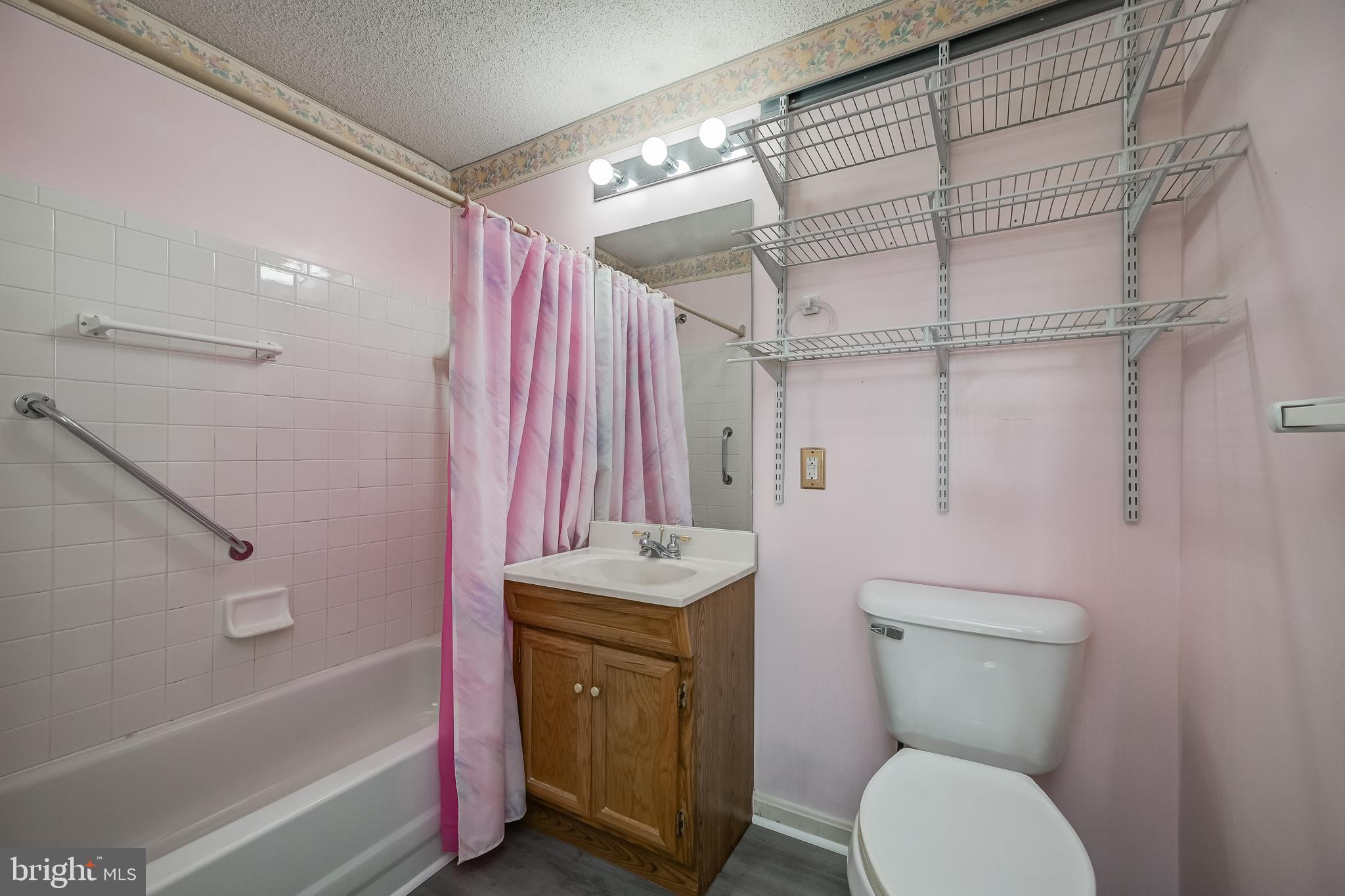 14202 Valleyfield Drive, Unit 338 Silver Spring, MD 20906 - Photo 29 of 38 a bathroom with a granite countertop bathtub sink vanity mirror and toilet