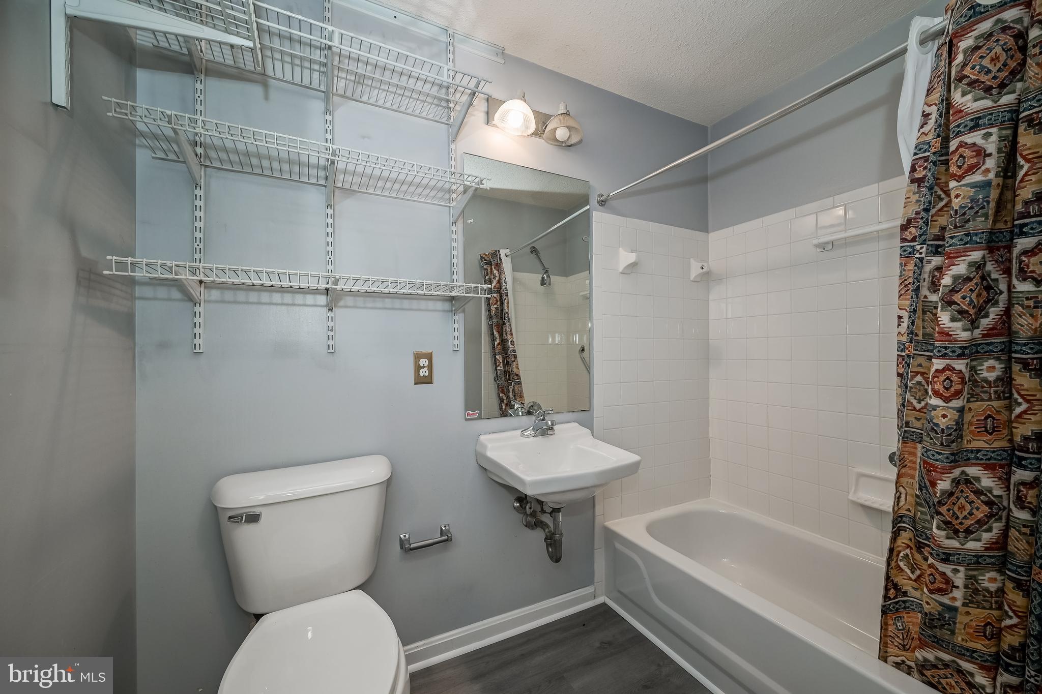 14202 Valleyfield Drive, Unit 338 Silver Spring, MD 20906 - Photo 37 of 38 a bathroom with a toilet a sink and shower