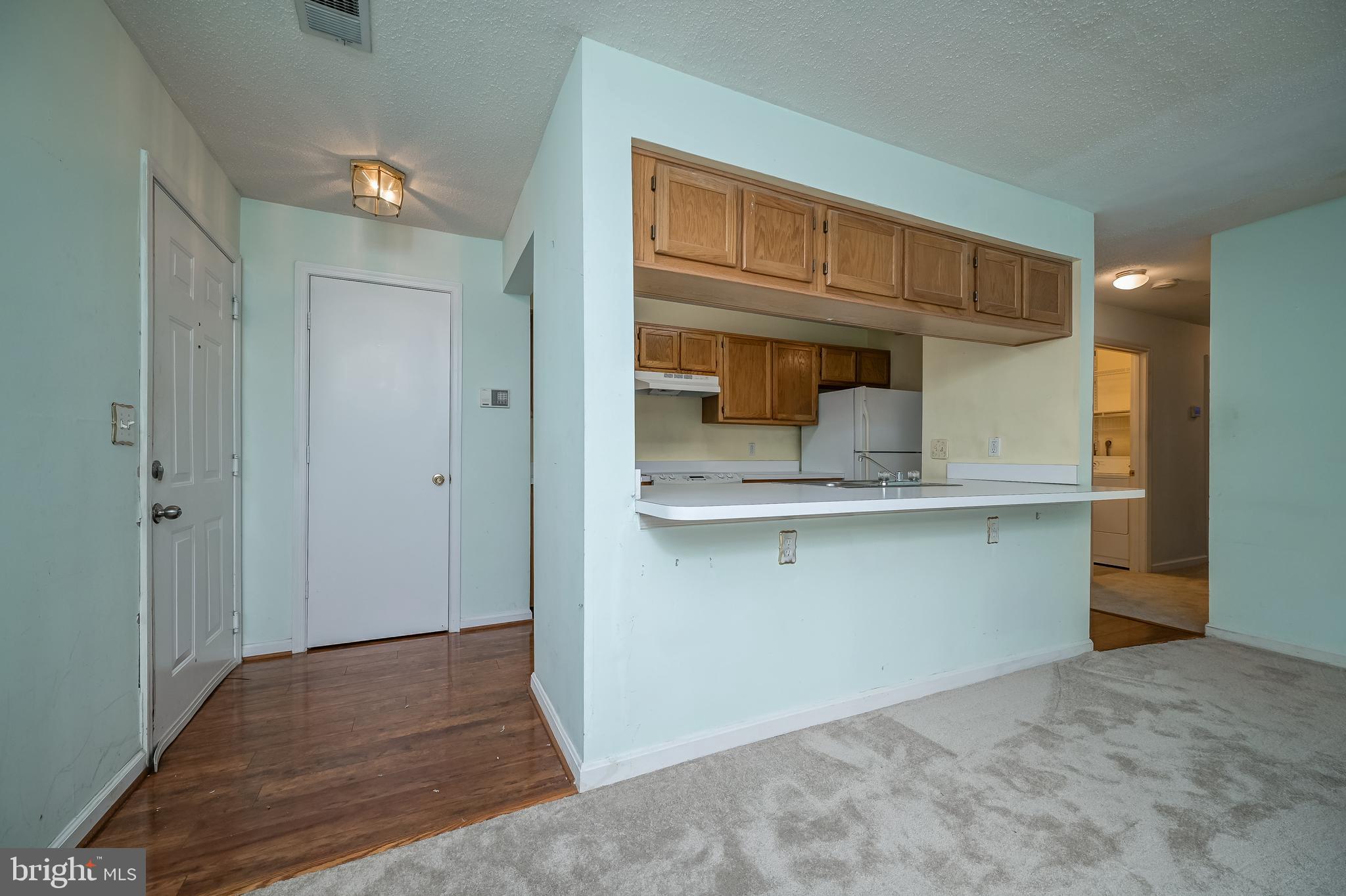 14202 Valleyfield Drive, Unit 338 Silver Spring, MD 20906 - Photo 5 of 38 a kitchen with a sink and cabinets