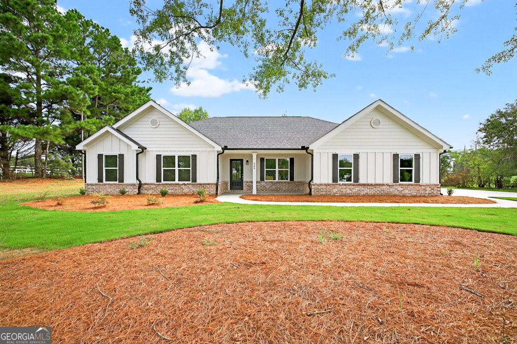 a front view of a house with a yard and porch