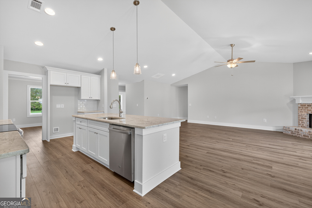435 Watson Road Winder, GA 30680 - Photo 13 of 36 a kitchen with kitchen island a sink stainless steel appliances and cabinets