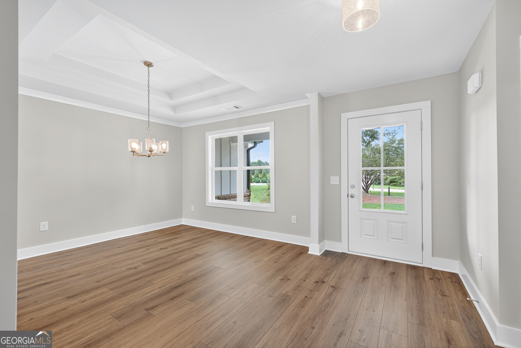 435 Watson Road Winder, GA 30680 - Photo 15 of 36 an empty room with wooden floor a ceiling fan and windows